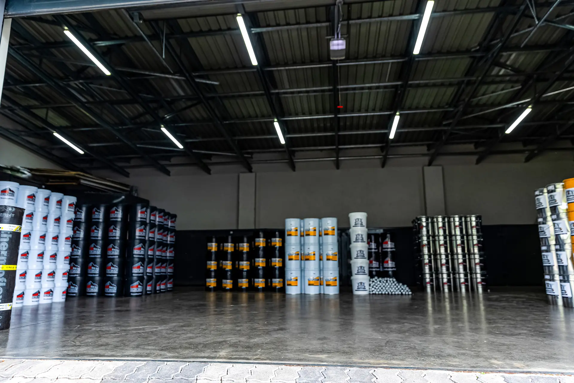 Organized warehouse with abundant stacks of roofing materials and supplies, essential for prompt local roof repair services near me.